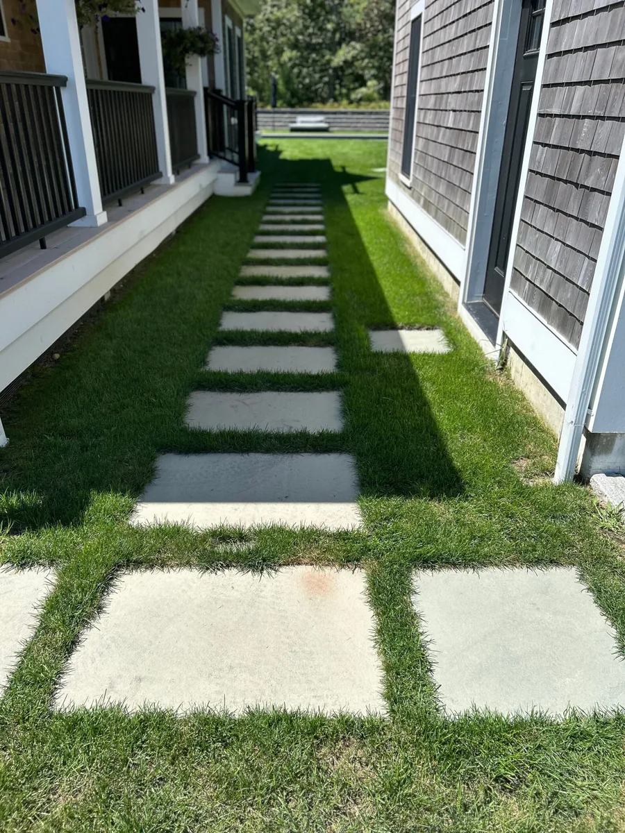 Bluestone stepping-stone path set into a manicured Martha's Vineyard lawn