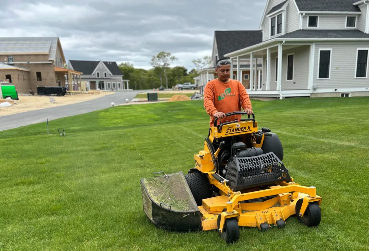 Professional mowing of a healthy lawn beside a Martha's Vineyard home